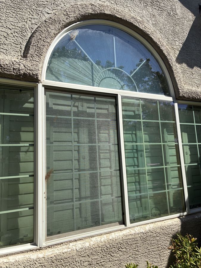 Arched window on a Las Vegas stucco home, before
