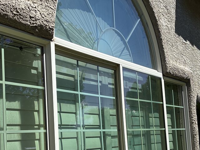 Same arched window, clear and spotless after cleaning