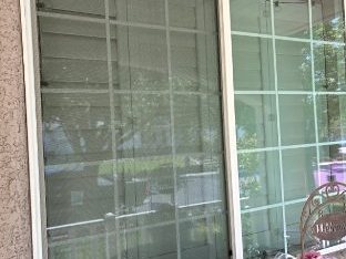 Front window with dusty, streaked glass before cleaning